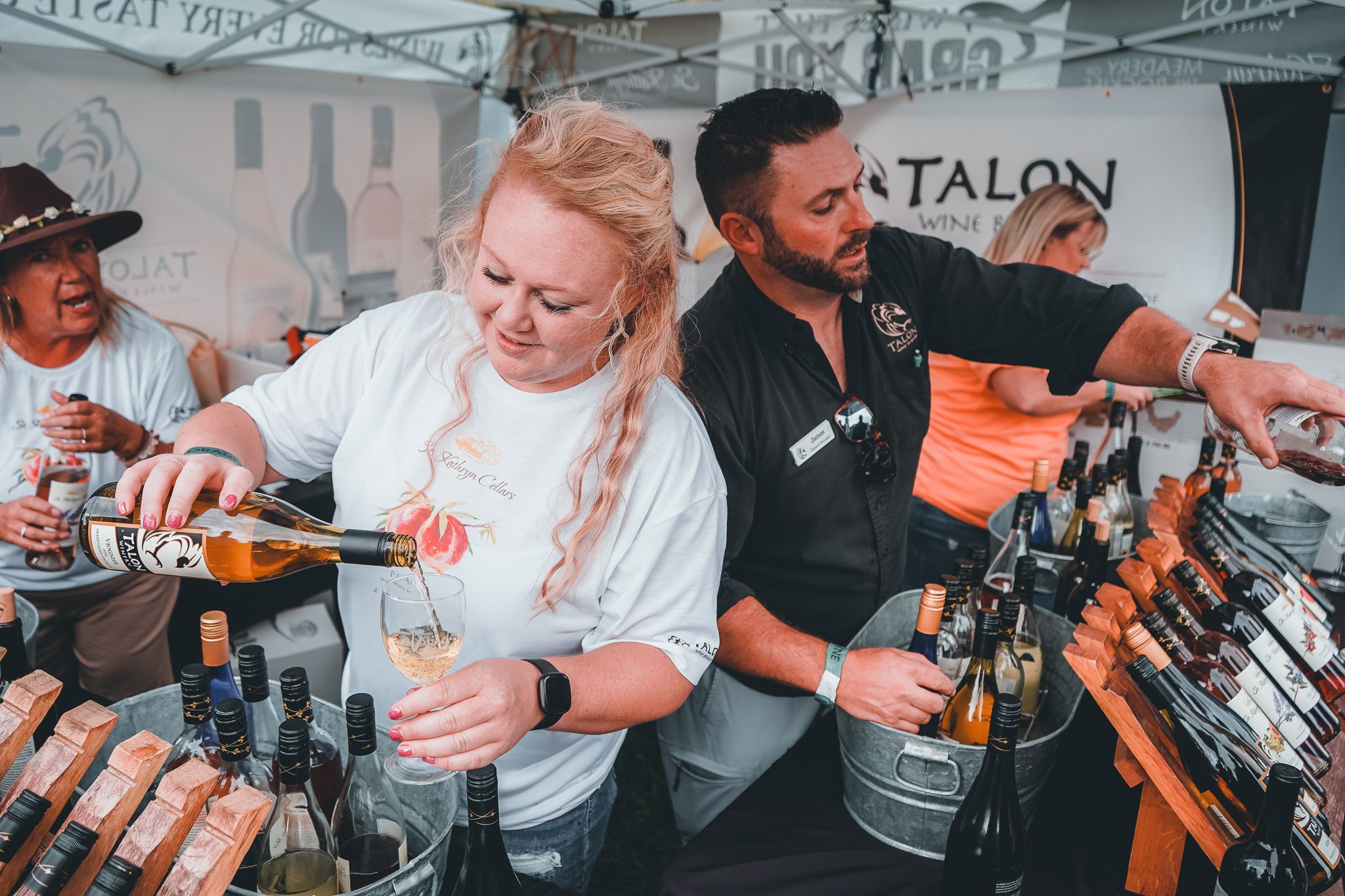 People pouring wine at a festival